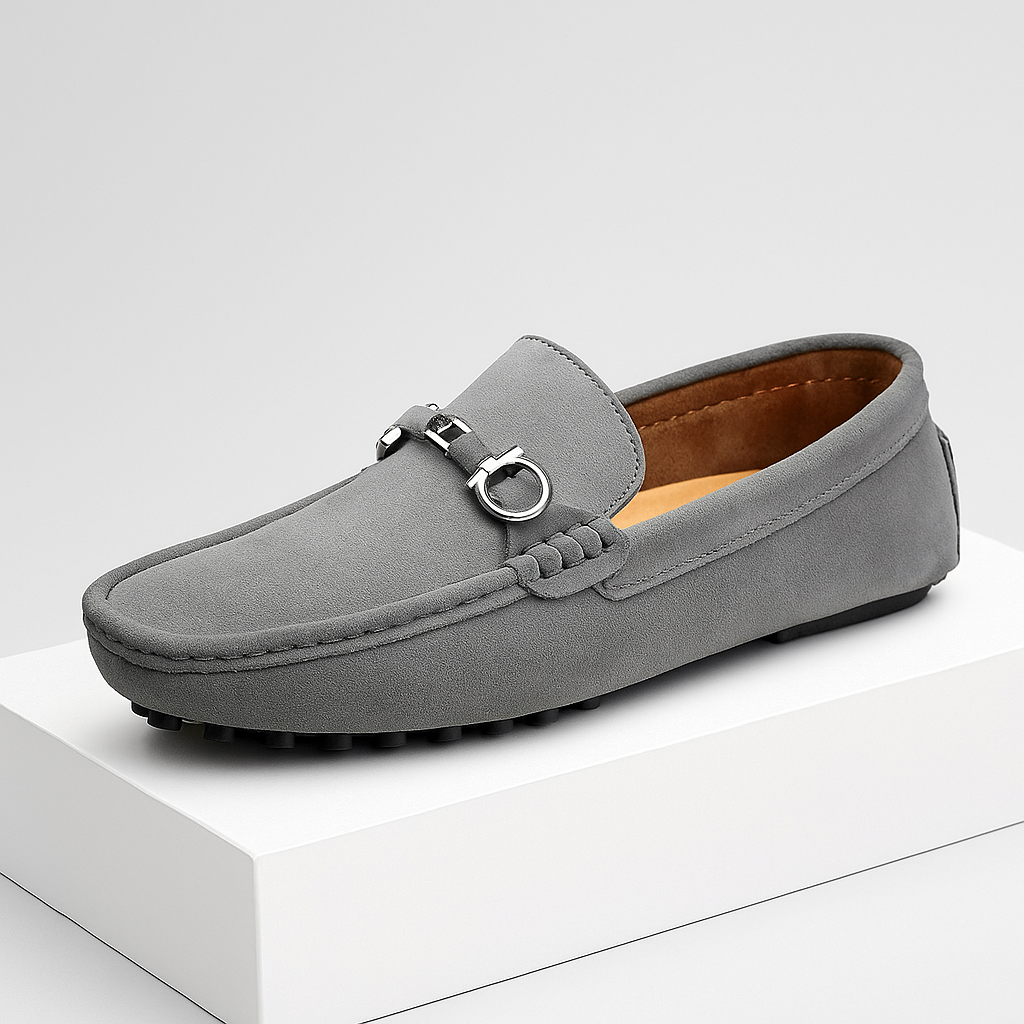 Close-up of men's dark brown suede bit loafers, featuring a gold-tone bit and comfortable flexible sole.