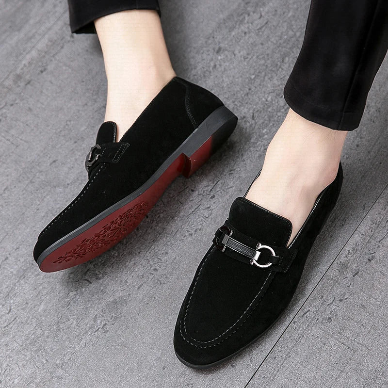Pair of men's gray suede bit loafers, a modern take on a classic men's footwear style.