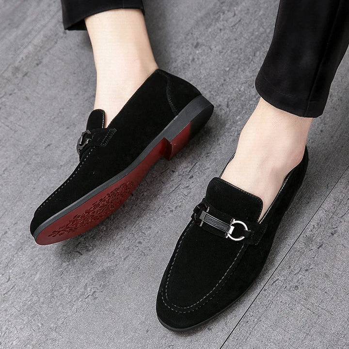 Pair of men's gray suede bit loafers, a modern take on a classic men's footwear style.