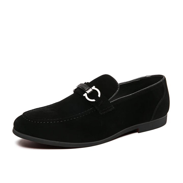 Detailed shot of the metal bit on a men's suede loafer, highlighting the craftsmanship.