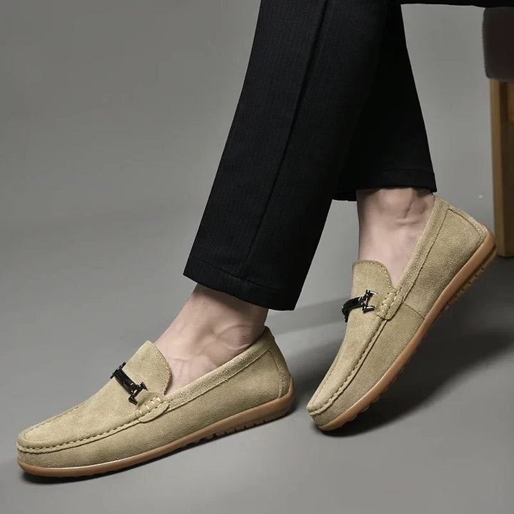 Side view of a grey men's suede loafer, emphasizing the comfort features and quality construction