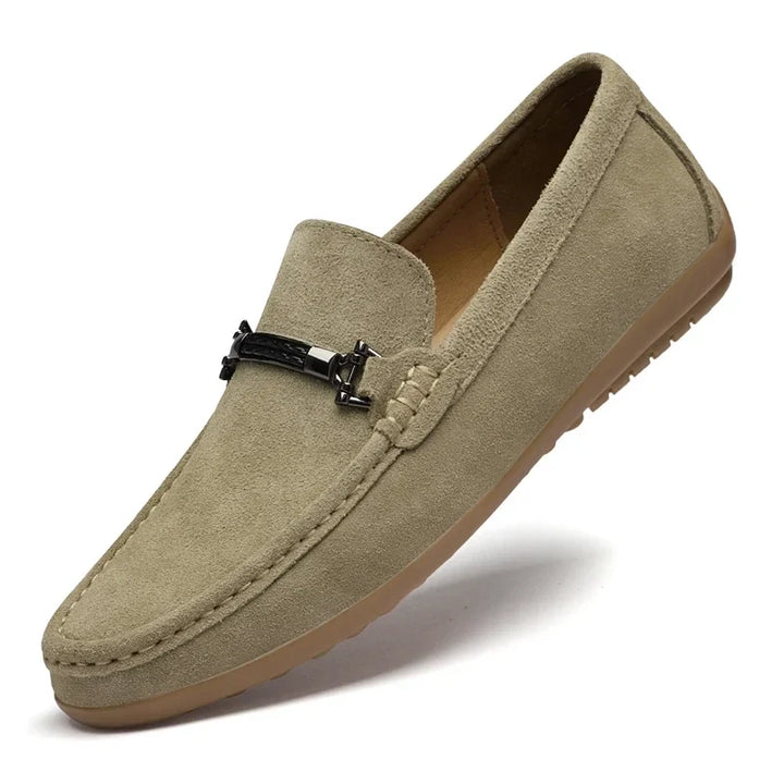 Detail of the stitching on a men's navy suede comfort loafer, highlighting craftsmanship