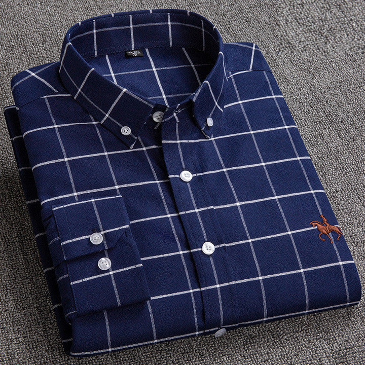Close-up of the fabric texture of a men's checkered button-down casual long-sleeve shirt.