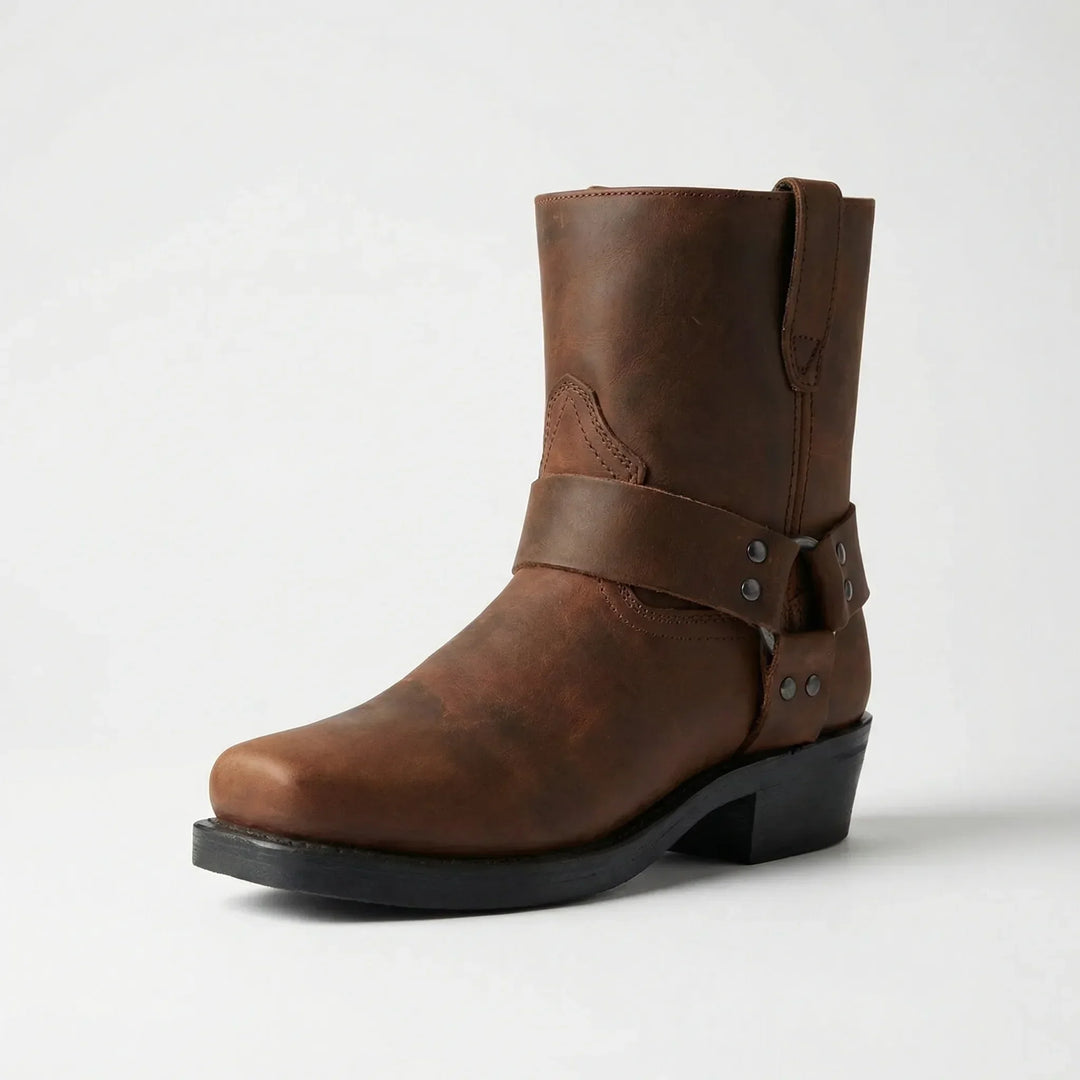 Stylish men's cowboy boots with a bold studded strap. Durable classic western footwear for modern fashion.