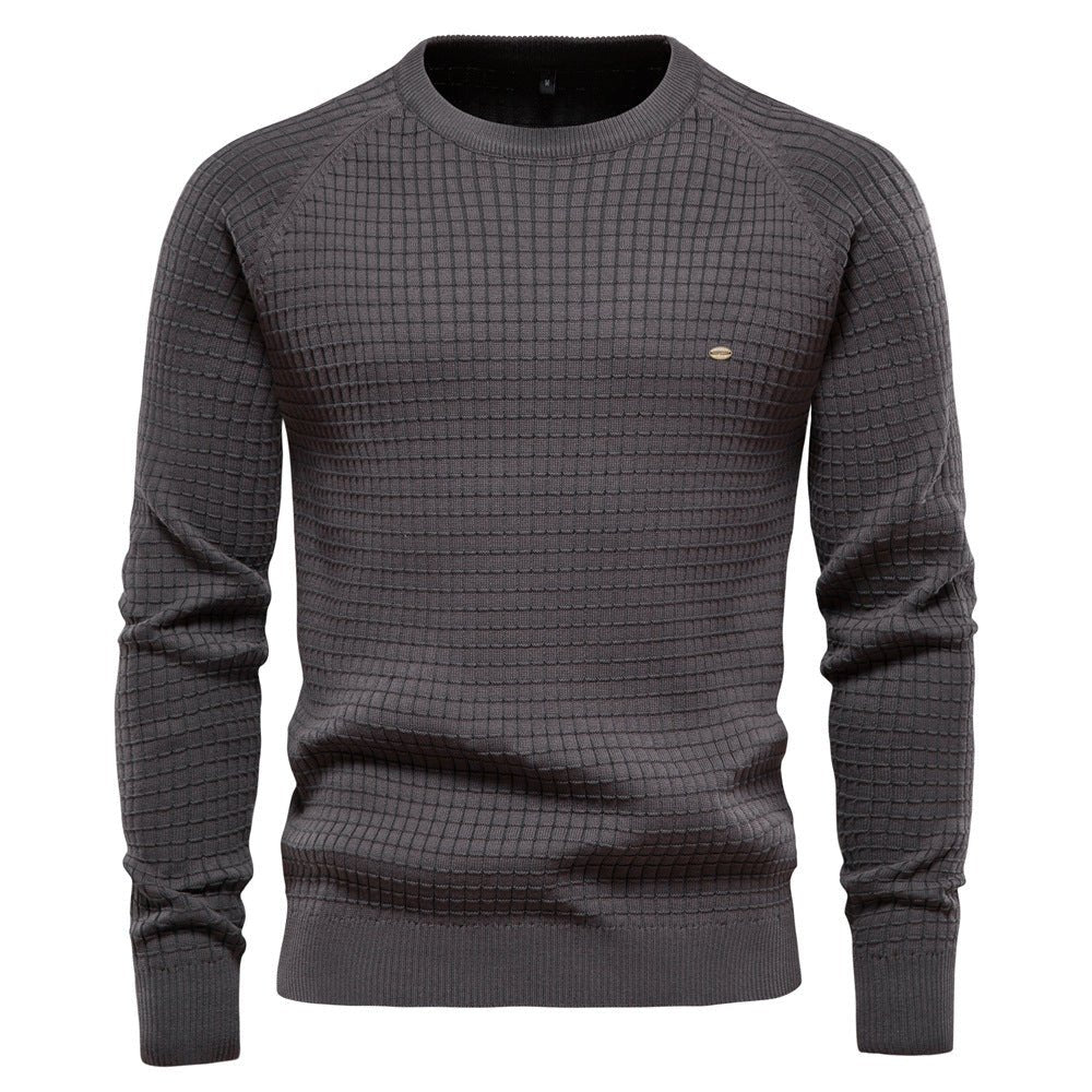 Close-up of a men's classic knit long sleeve pullover, highlighting the rich texture