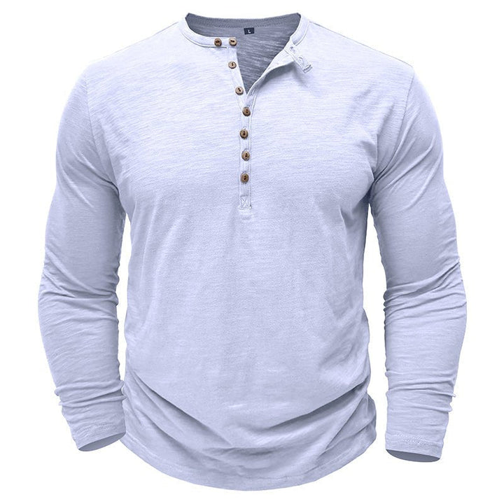 A stack of men's classic henley shirts in various colors, showcasing options.