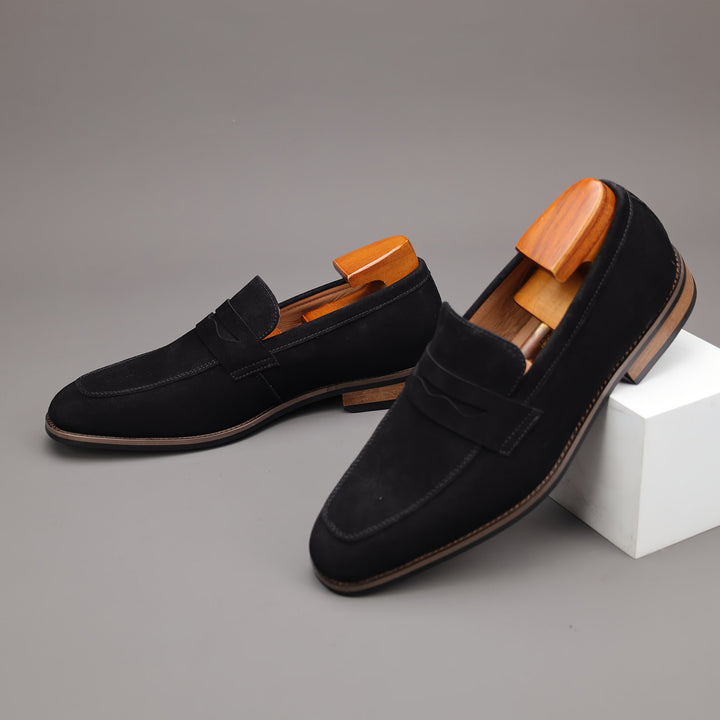 Black penny loafers for men, classic slip-on style shoes offering comfort & effortless elegance for any outfit.