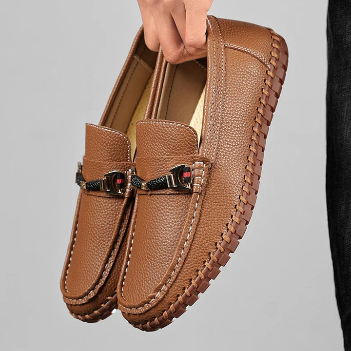 Model wearing men's classic brown leather bit loafers with a suit, showcasing sophisticated men's fashion