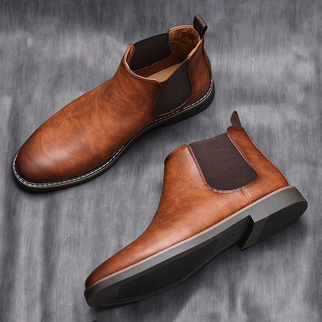 Pair of men's sleek black Chelsea boots, a versatile and comfortable footwear choice