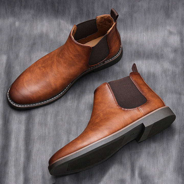 Pair of men's sleek black Chelsea boots, a versatile and comfortable footwear choice