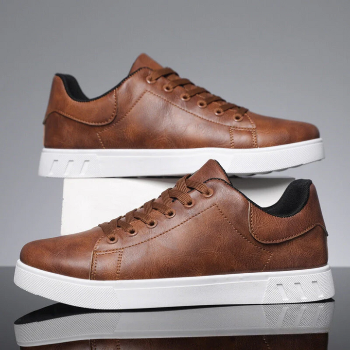 Close-up of men's classic white low-top sneakers, showing textured upper and laces