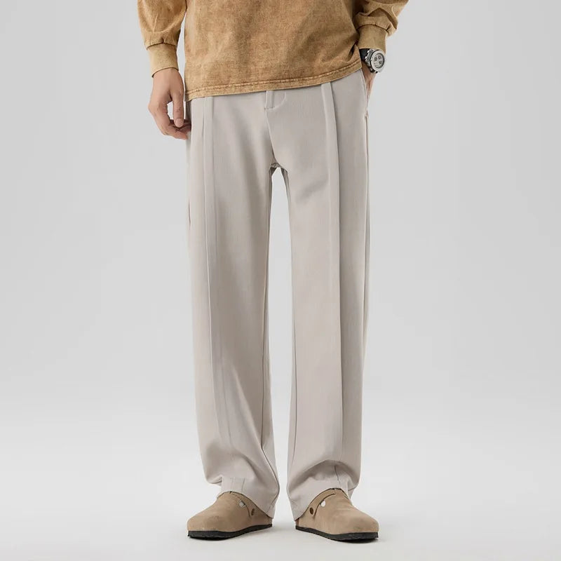 Men's elegant khaki drape trousers, pleated for refined comfort & versatile style.
