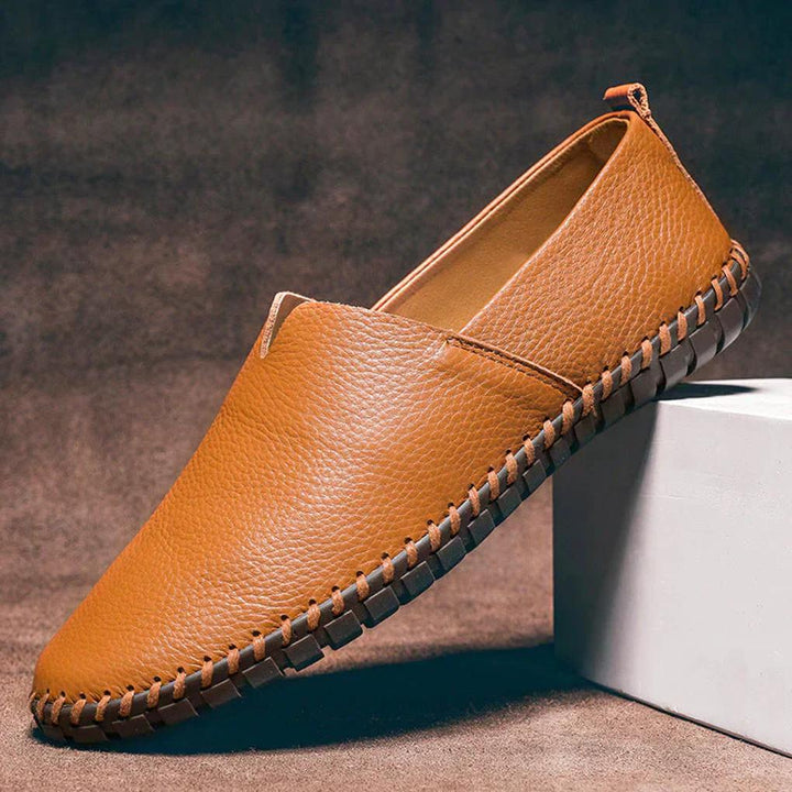 Close-up of dark blue men's matte slip-on loafers, highlighting elegant finish & comfort features.