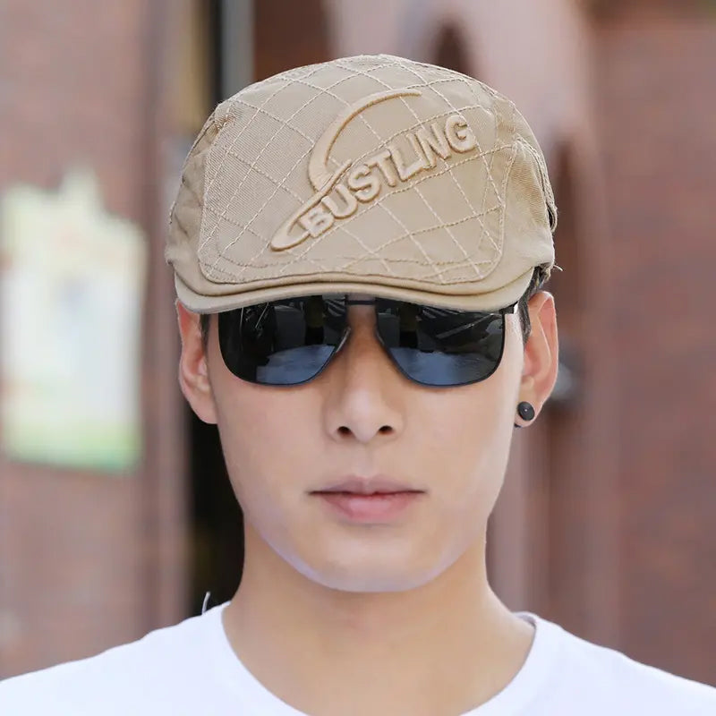 Stack of multiple men's embroidered cotton berets, available in various colors, stylish headwear.