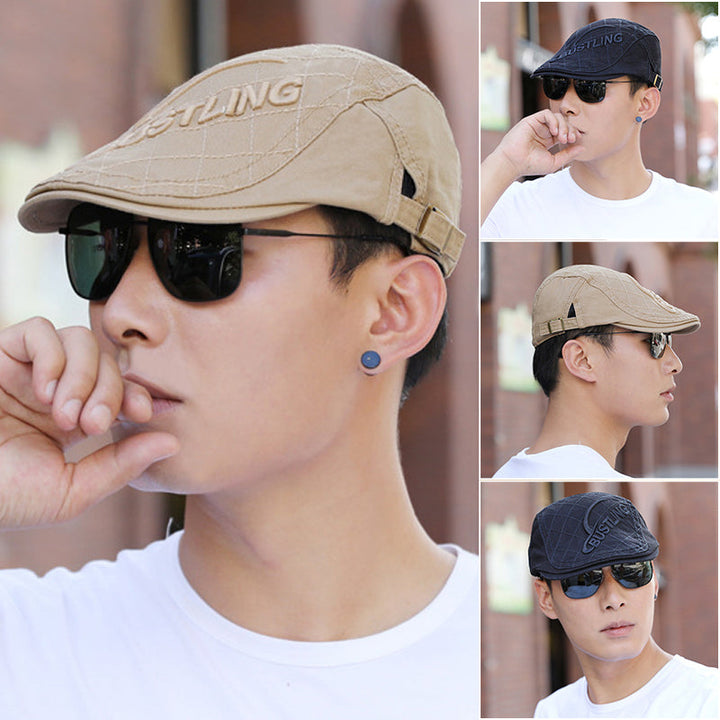 Close-up of the front of a men's embroidered cotton beret, showcasing the detailed stitching and fabric.