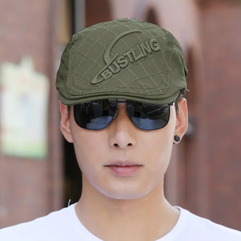 Back view of a men's embroidered cotton beret, displaying its seamless construction as a men's hat.