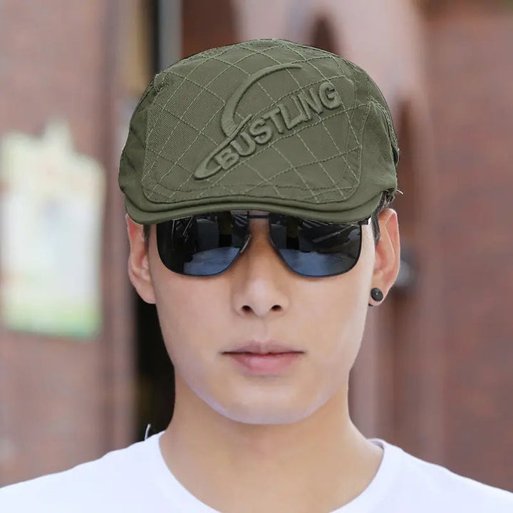 Back view of a men's embroidered cotton beret, displaying its seamless construction as a men's hat.