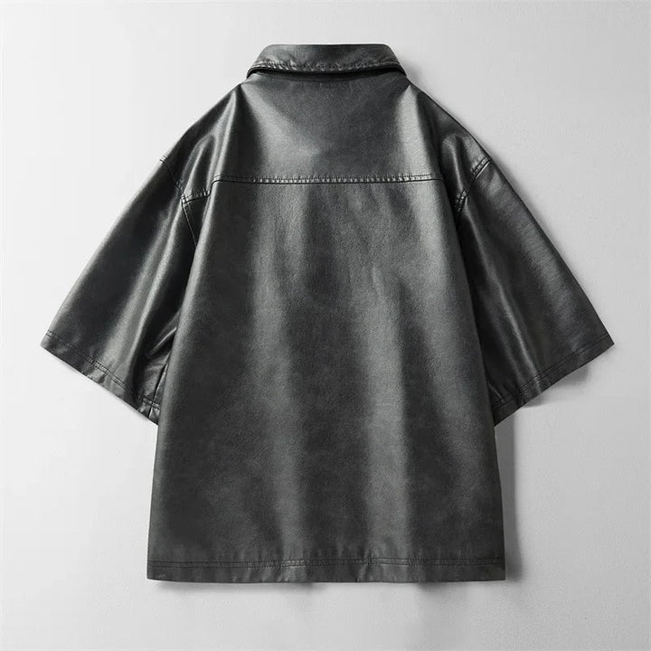 Detailed shot of the collar and buttons on a men's stylish genuine leather short-sleeve top.