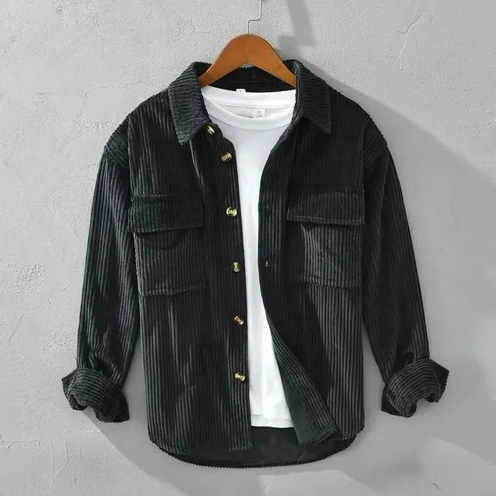 A stack of folded men's ribbed corduroy overshirts in various colors, stylish and practical
