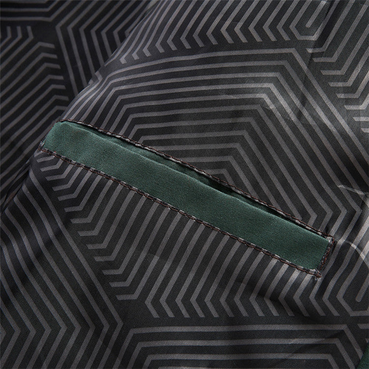 Close-up of fabric texture on men's lightweight vintage green bomber jacket, military style.