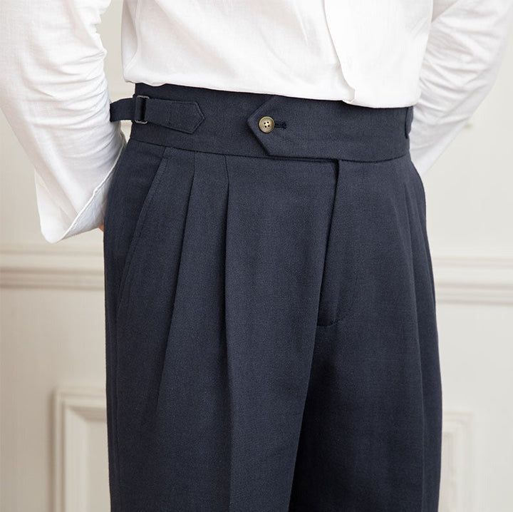 Textured fabric of high-waisted men's pleated trousers, designed for luxurious formal and smart casual wear.
