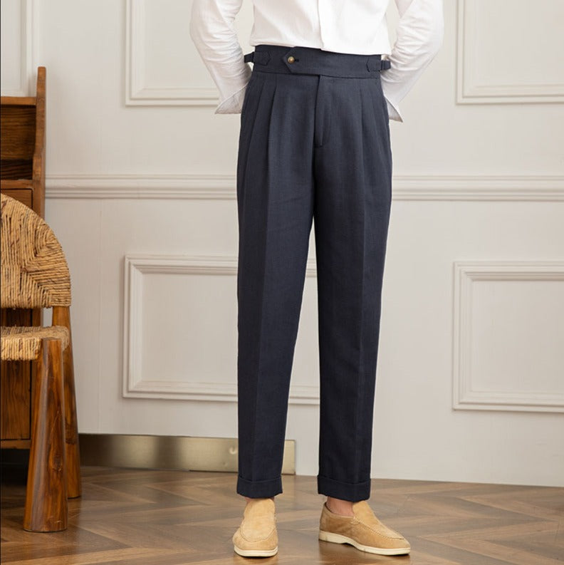 Men's high-waisted pleated trousers styled with a shirt, exuding elegant Italian formal fashion.