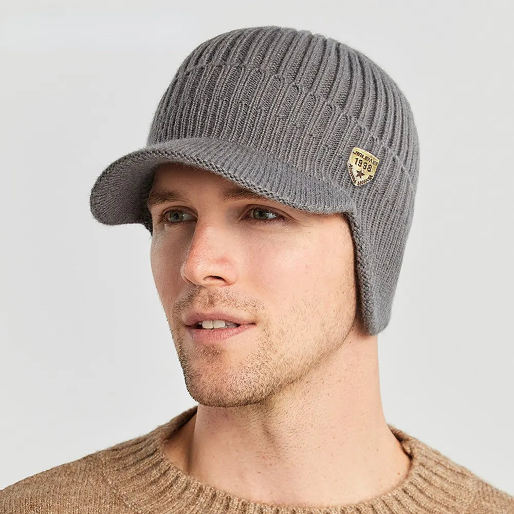 Stay warm with this men's knitted beanie featuring ear flaps, essential cold weather outdoor headwear.