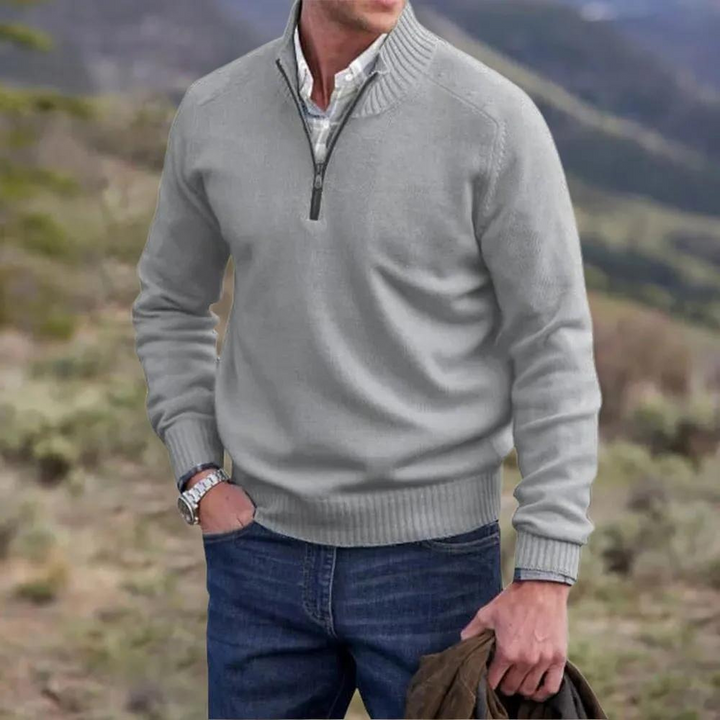 Close-up of the half-zip detail on a men's knitted pullover jumper, showcasing the quality knitwear.