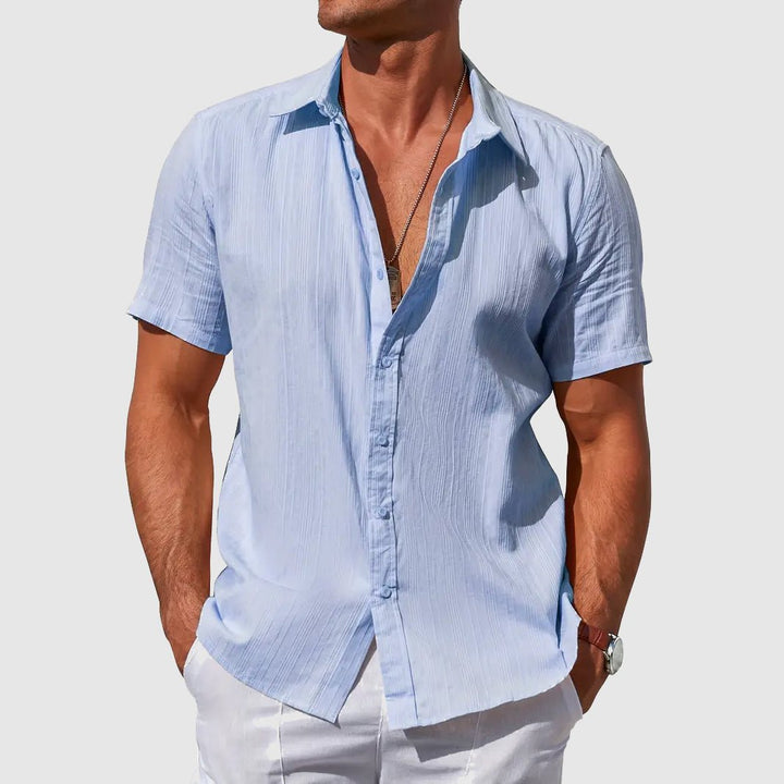 Men's light blue textured short sleeve button-front shirt for casual summer wear.