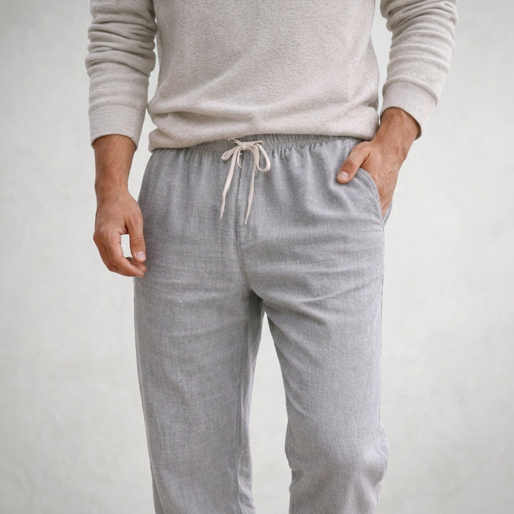 Man wearing stylish men's linen pants, paired casually for comfortable summer wear.