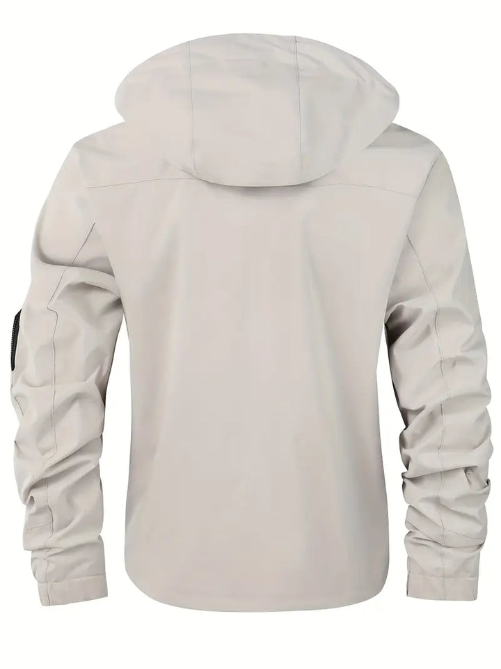 Men's lightweight hooded outdoor jacket in action, windproof & waterproof, keeping you dry & comfortable outdoors.