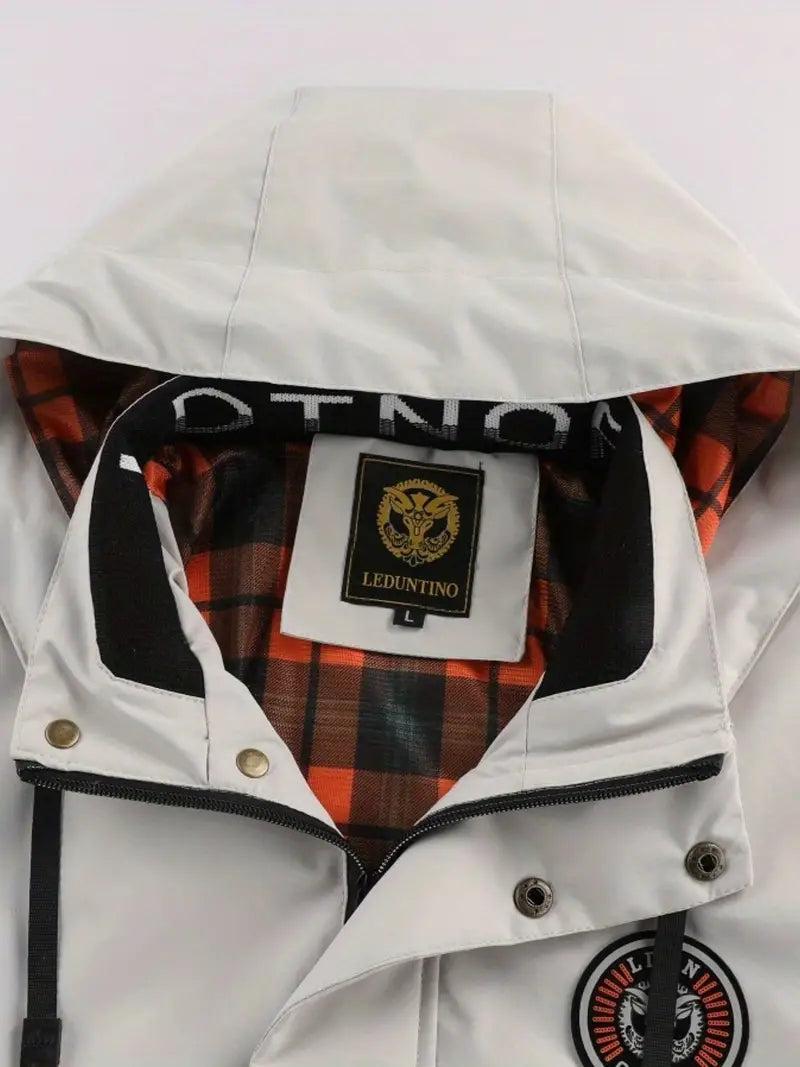 Man hiking in a lightweight hooded outdoor jacket, windproof & waterproof, offering excellent weather protection.