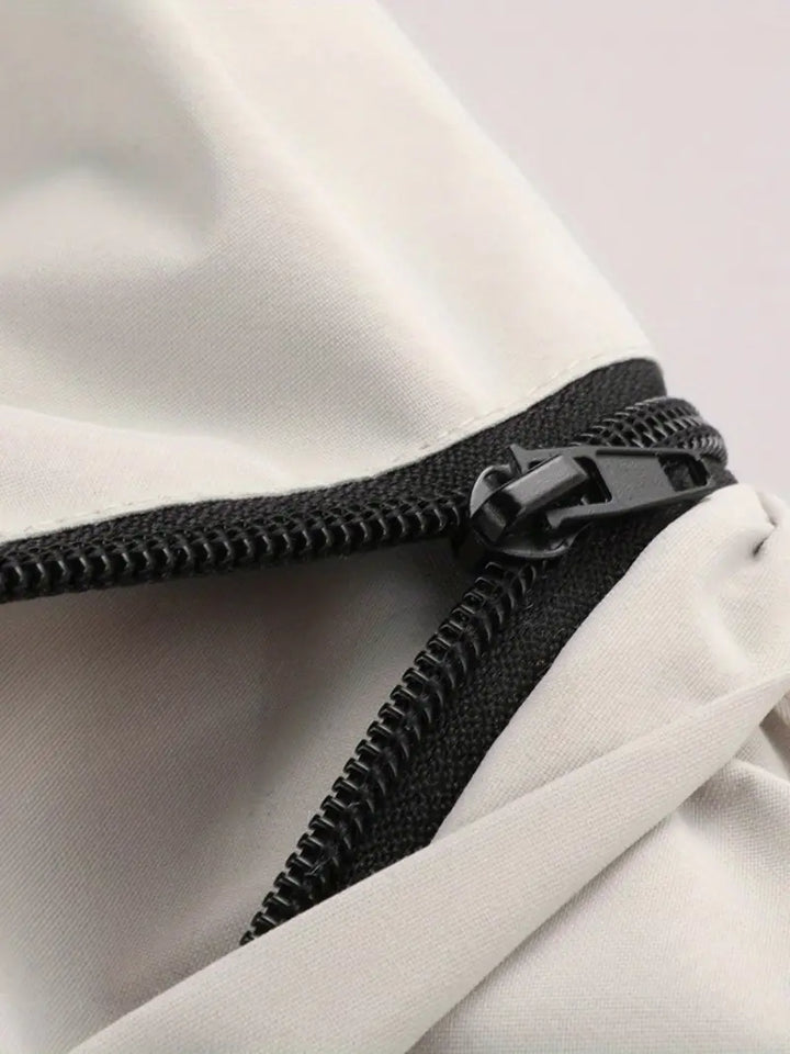 Close-up of lightweight men's outdoor jacket fabric, highlighting windproof & waterproof texture and quality.