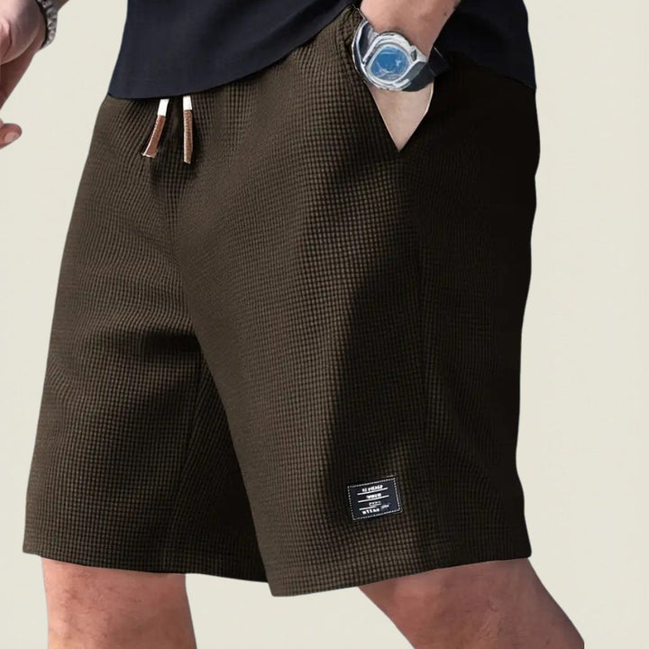 Lightweight men's casual shorts featuring an elastic waist & drawstring for summer comfort.