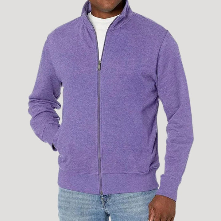 A folded men's spring jacket, illustrating its packability and lightweight nature for travel.