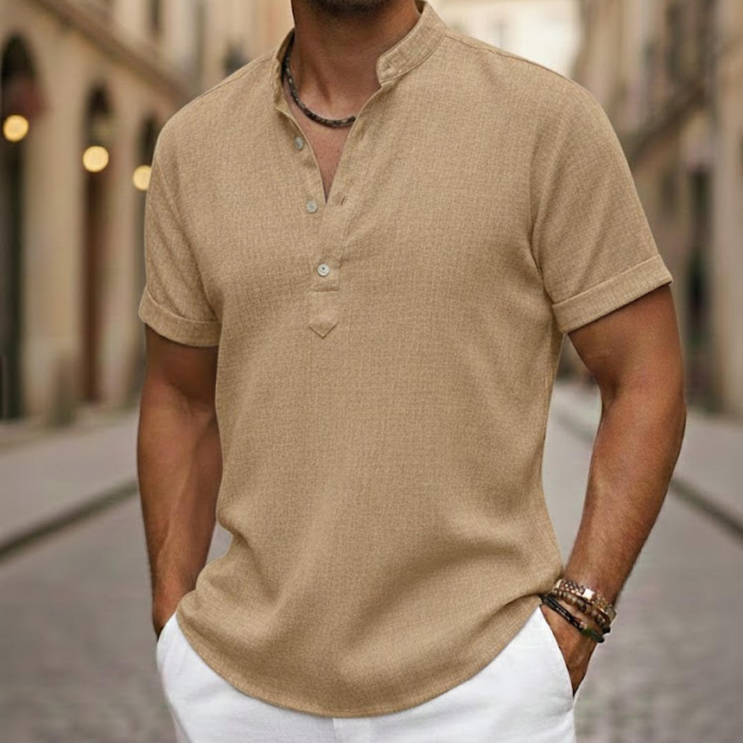 Detail of men's short sleeve linen blend henley shirt, highlighting fabric texture & button placket, summer style.