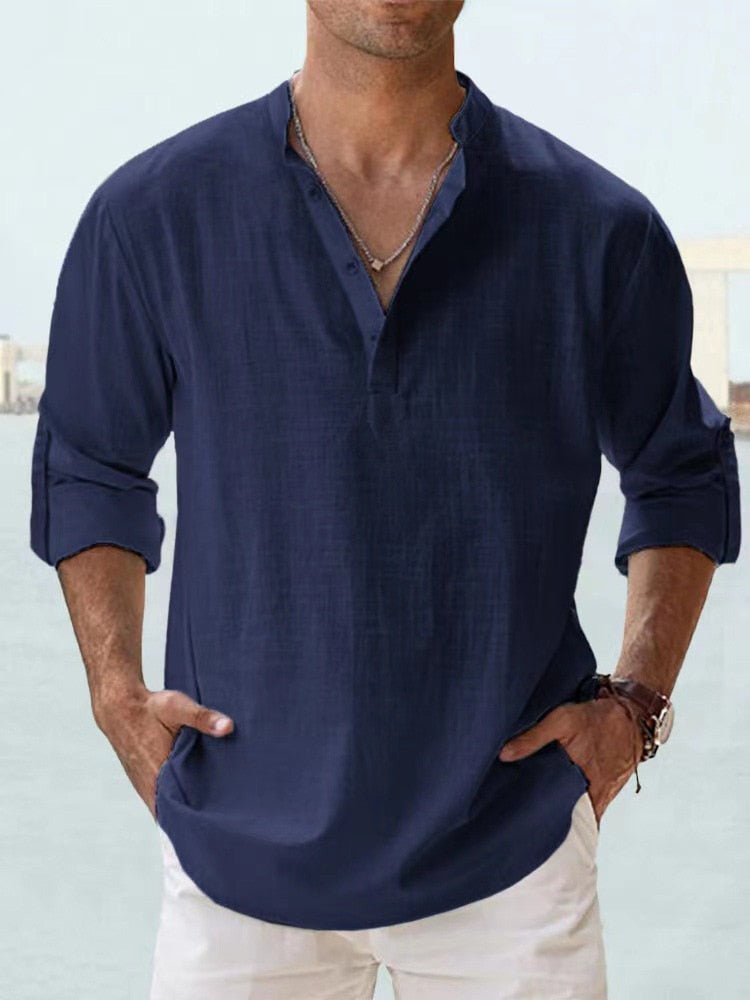 Man wearing a relaxed fit long sleeve Henley shirt with mandarin collar, perfect for casual summer outings.