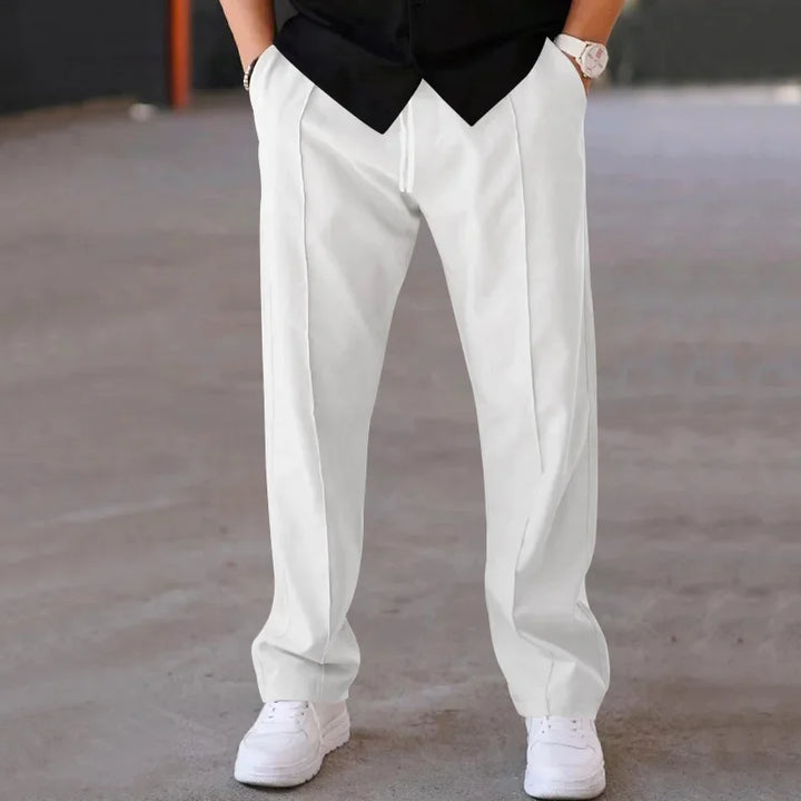 Men's loose-fit formal trousers paired with a dress shirt, a perfect example of classic style.