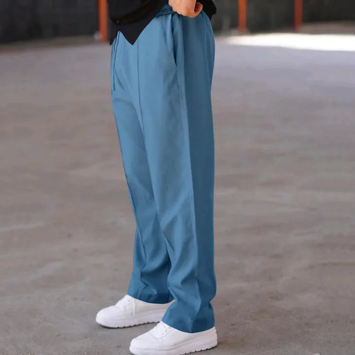 Detail of the waistband and belt loops on men's loose-fit formal trousers, ideal for formal wear.