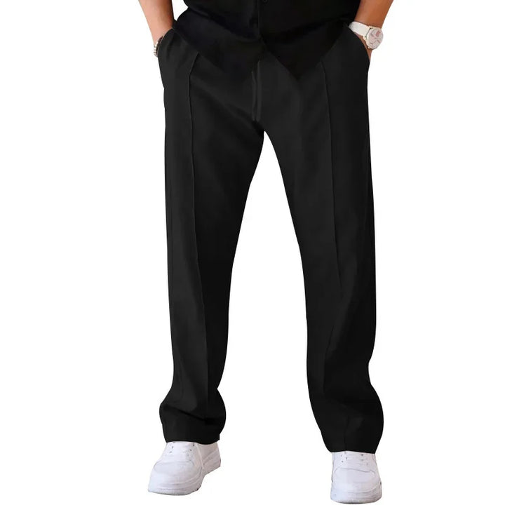 Close-up of the zipper and button closure on men's loose-fit formal trousers, quality details.