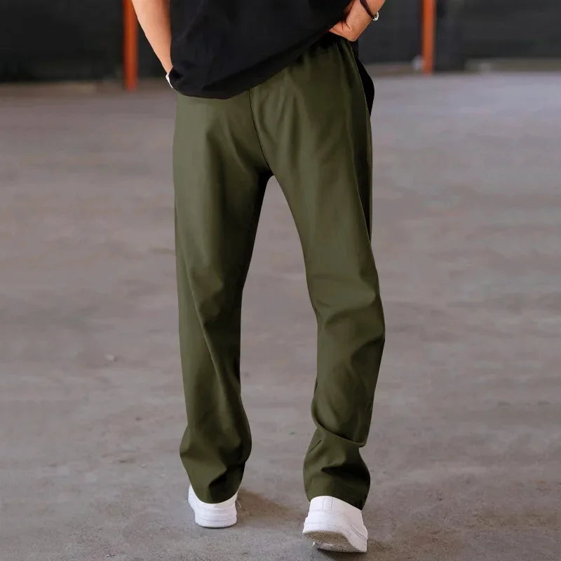Close-up of the fabric texture on men's loose-fit formal trousers, emphasizing quality material.