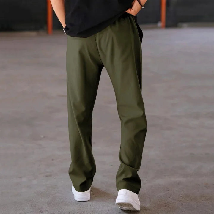Close-up of the fabric texture on men's loose-fit formal trousers, emphasizing quality material.