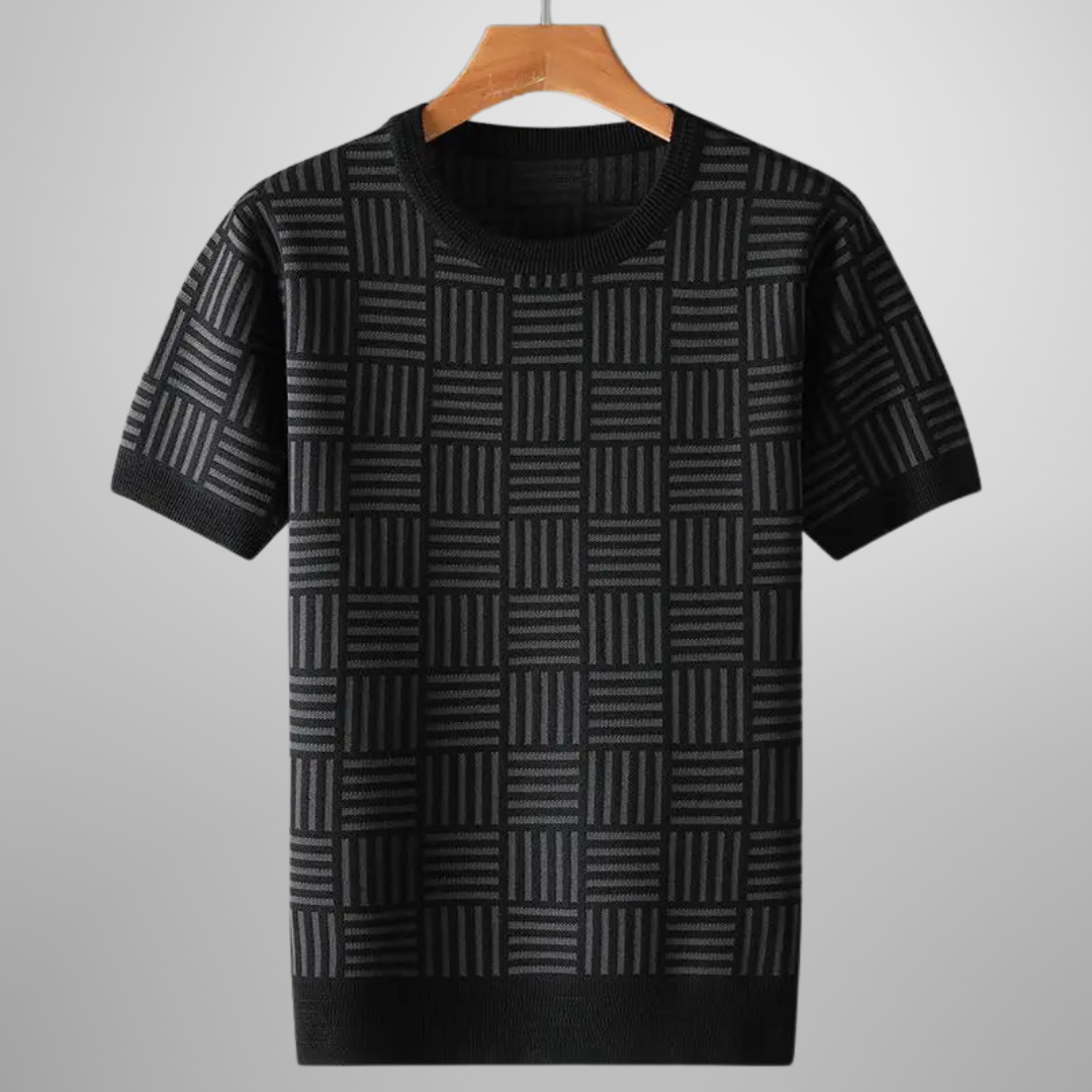 Close-up of men's knit top featuring a stylish geometric pattern and ribbed details on sleeves.