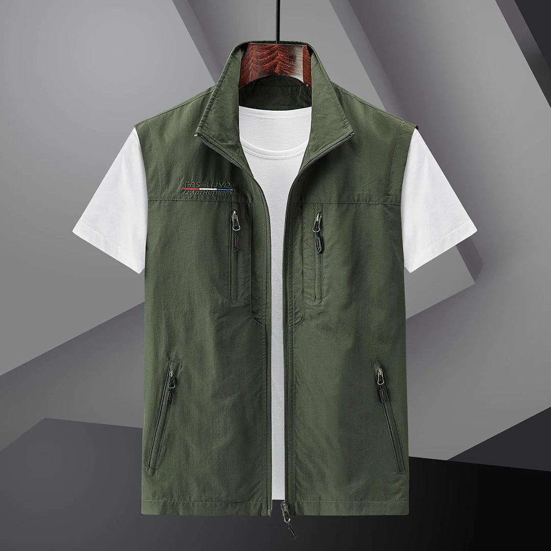 Lightweight men's outdoor utility vest. Multi-pocket design perfect for summer travel, fishing, hiking. Breathable fabric.