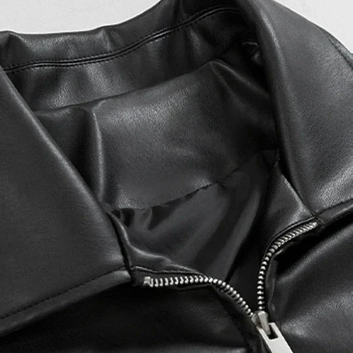 Close-up of the faux leather texture on a men's black oversized bomber jacket, showing detail