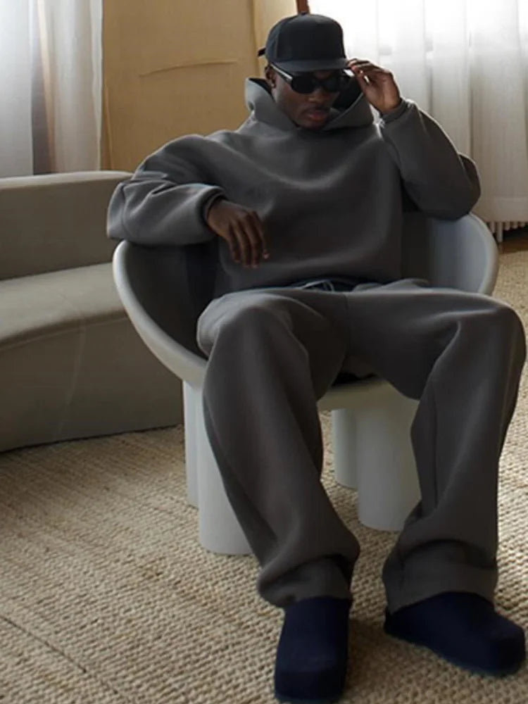 Versatile men's oversized tracksuit set with hoodie and joggers. A relaxed fit casual outfit for modern men.