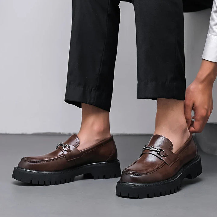 Formal men's loafers, black and polished, offering a sharp and sophisticated look for any event.
