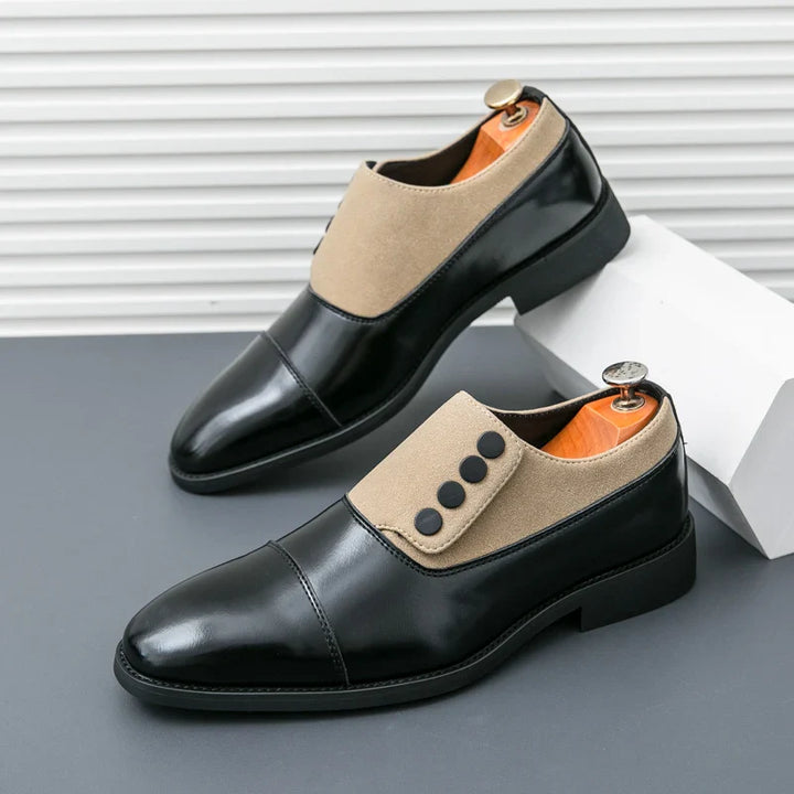 Detailed view of a men's brown polished leather loafer, emphasizing the button and shiny finish.