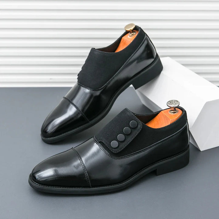 Side profile of a men's black polished leather loafer, showing the sophisticated slip-on style.