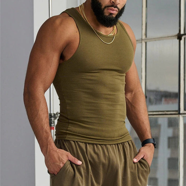 Product shot of men's premium sleeveless gray tank top folded neatly, cotton blend material.